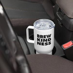 Elevated travel mug with "Brew Kindness" text design sitting in a car cup holder 
